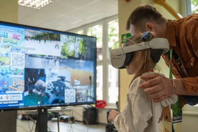 Girl in a VR headset at the simulator screen