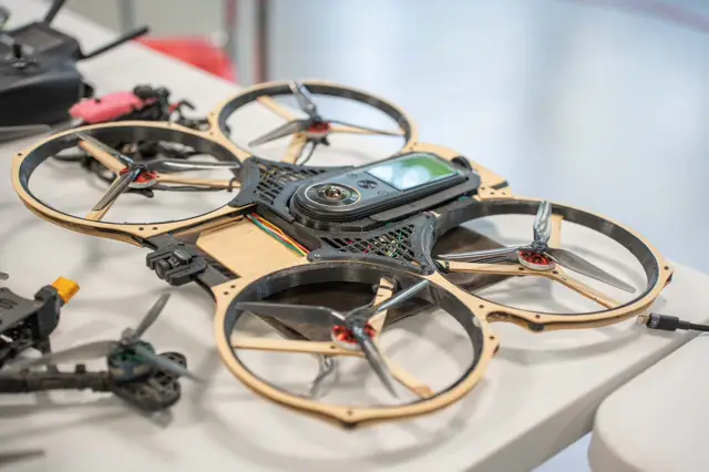 FPV frames and drones on a workshop table