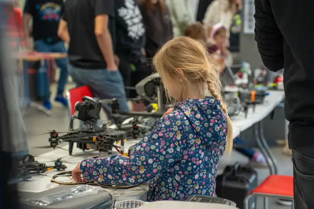 Girl at a drone workbench during the workshops